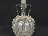 an image of a glass bottle with a crown on it