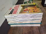 many books stacked on top of each other on a table