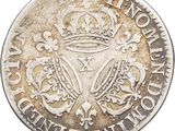 a silver coin with a crown on top of it