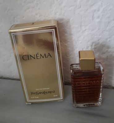 an image of a bottle of perfume next to a box of perfume
