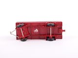 a red train car that is sitting on a white surface