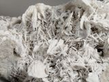 a close up of a piece of white rock with a lot of white stuff on it