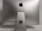 an apple computer sitting on top of a white table