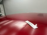 a red couch with a tag on it in a room