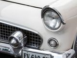 a close up of a white car with a license plate on it