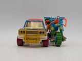 a toy truck with a motorcycle on the back of it