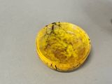 a yellow bowl sitting on top of a table