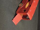 a red toy truck that is sitting on a black surface