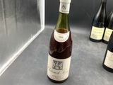 several bottles of wine are lined up on a counter