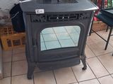 a stove sitting in the corner of a room
