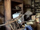 a pile of boxes and a chair in a room