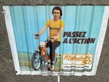 a poster of a man riding a bike on the street