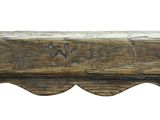 an old wooden bench with writing on the top of it