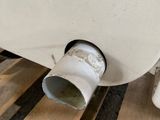 a white toilet sitting on top of a wooden pallet