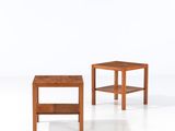 two small wooden tables sitting on top of a white surface