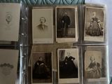 a lot of old photos of men and women on display