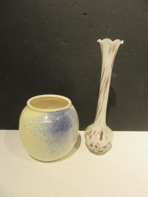 two vases sitting on a table next to each other