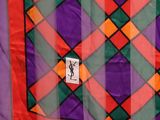 purple, green, orange, and red plaid fabric with a monogrammed y on it