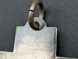 a close up of a metal object with a ring on it