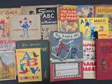 several children ' s books are lined up on a black surface
