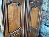 a wooden armoire with a mirror on top of it