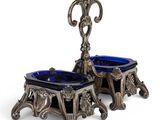 a pair of blue glass bowls sitting on top of a metal stand