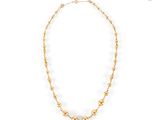 a gold beaded necklace on a white background