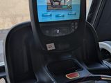 a car dashboard with a monitor on it and a steering wheel