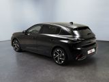 the rear end of a black car parked in a room