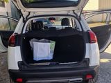 a car with its trunk open on the side of the road
