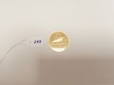 a gold coin sitting on top of a white table