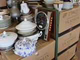 a pile of plates and bowls on a carton in a room