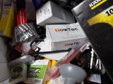 a pile of assorted electronics and other items in a bin