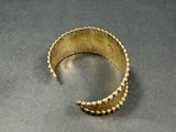 an image of a gold ring sitting on top of a table