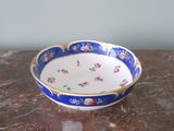 a blue and white bowl sitting on a marble table