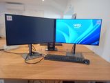 two monitors and a keyboard on the desk