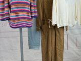 three pieces of clothing are hanging on a clothes rack in a room