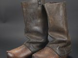 a pair of brown leather boots on a black background