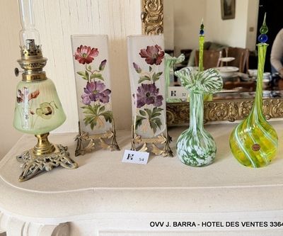 many vases sitting on a table with a mirror in the background