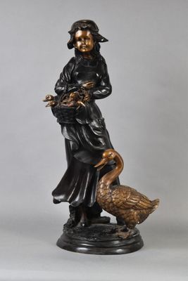 statue of a woman with a goose and a bird on a pedestal