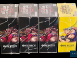 three boxes of one piece cards are sitting on a table