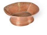 an old copper bowl on a white background with a hole in the middle