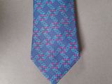 a blue neck tie with a pink and blue design on it