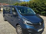 the blue van is parked in a gravel lot near some bushes