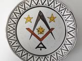 a decorative plate with a masonic symbol on it