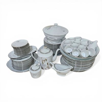 a lot of dishes and cups on the table
