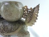 a statue of a turtle holding a fish on its back