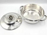 a silver pot with a lid on a white surface