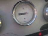 a close up of a clock on the dashboard of a car