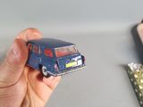 a person holding a small toy car in their hand